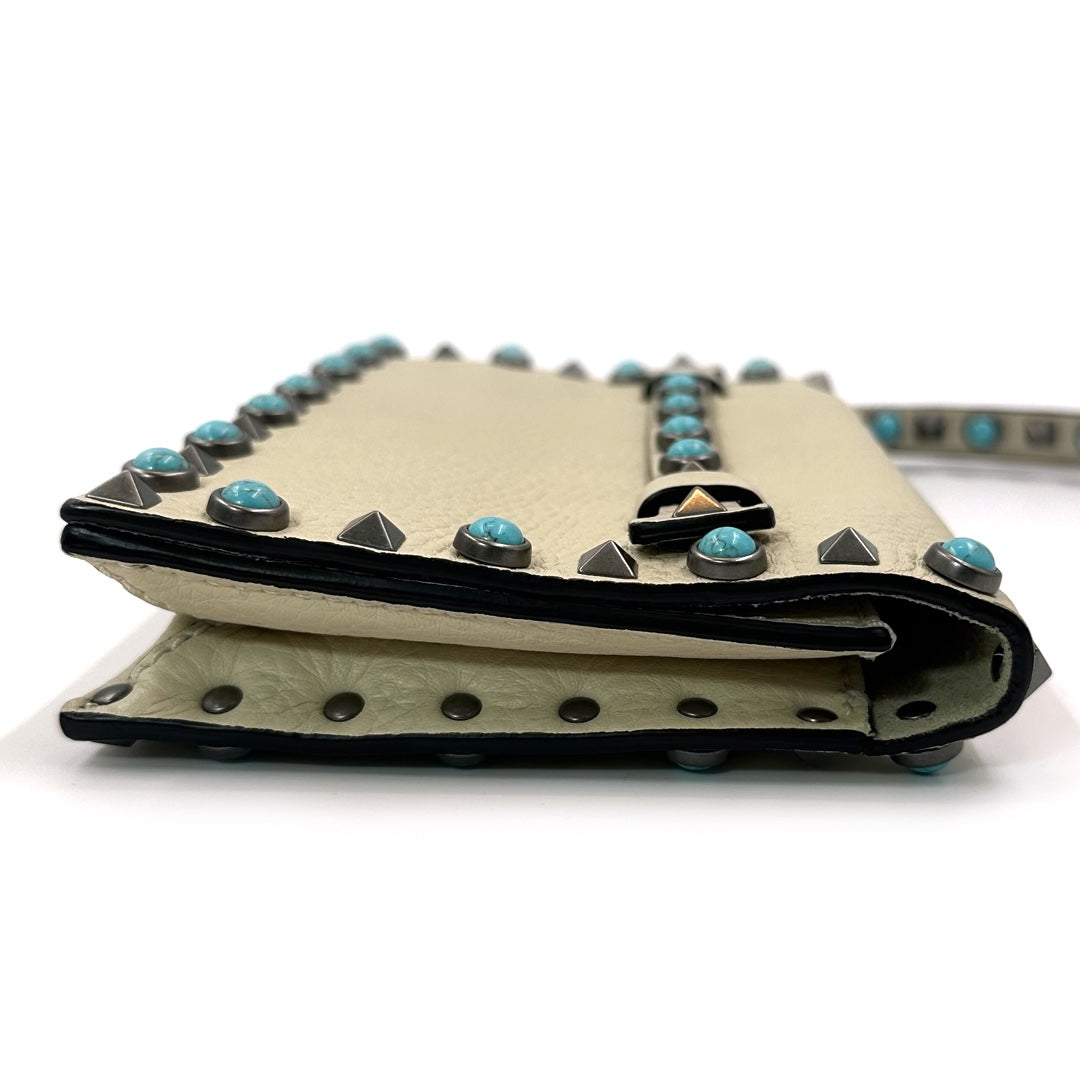 Valentino Garavani Rockstud Rolling Clutch in Beige Leather with Turquoise Cabochons and Antique Silver Studs - Gemaee  UAE